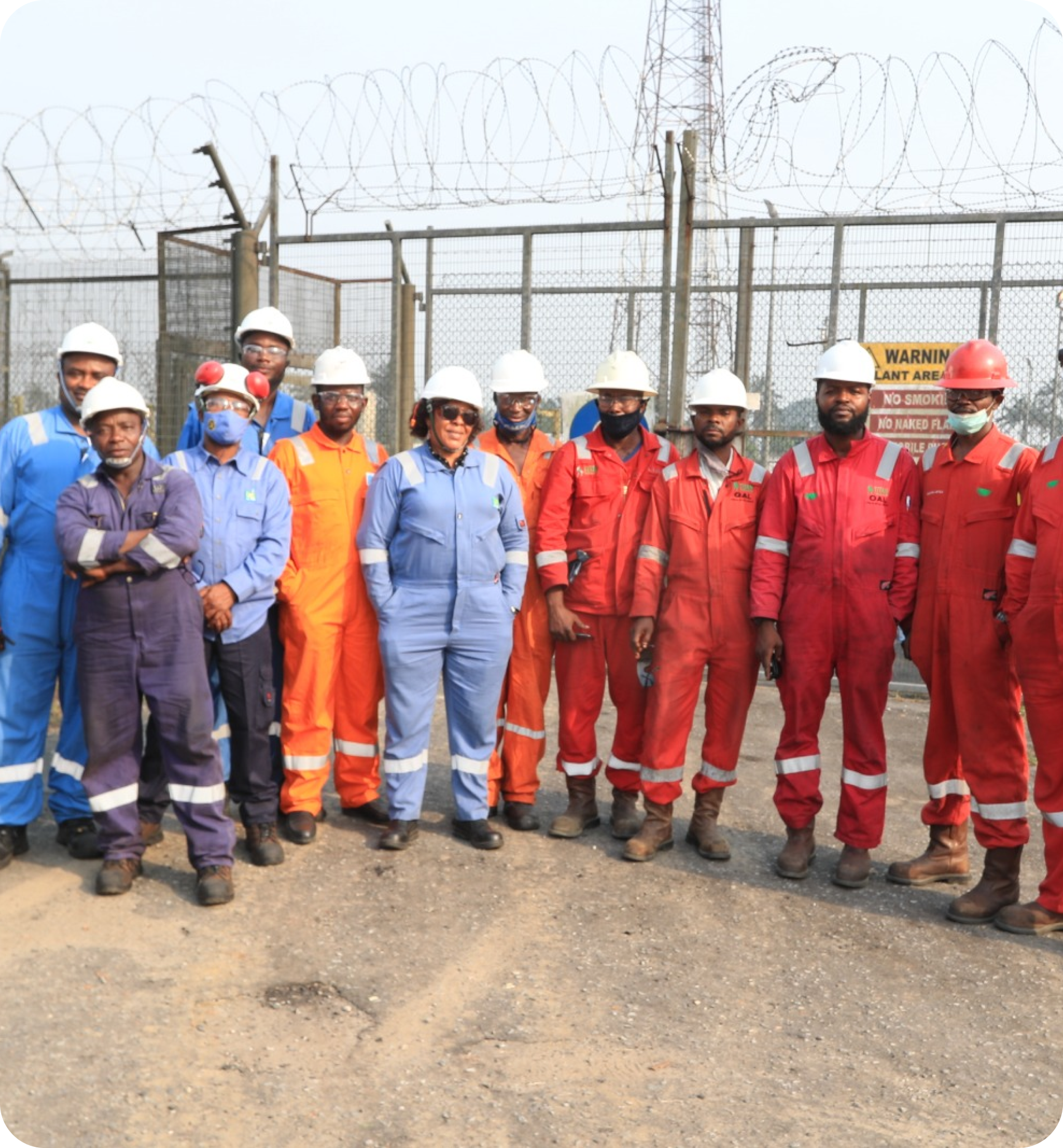 Dark skinned man in a green vest and yellow helmet